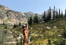 Woman points to mountain scenery