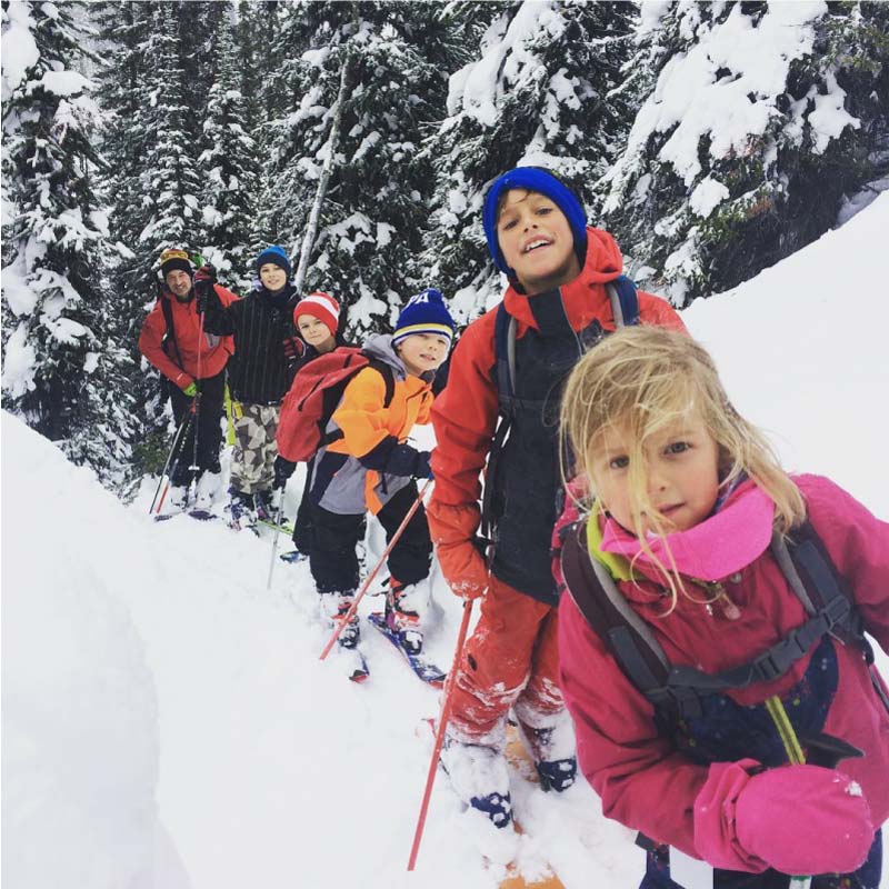 group of children skiing in backcountry